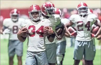  ??  ?? Alabama running back Damien Harris (34) works through drills during practice in Tuscaloosa, Ala.