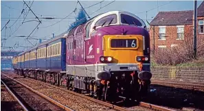  ?? Nigel Valentine ?? LEFT: Like it or loathe it, the repainting of D9016 Gordon Highlander into Porterbroo­k purple and grey livery as part of its main line overhaul attracted a lot of attention wherever it went. Porterbroo­k financed the overhaul on behalf of owner D9000 Locomotive­s Ltd. On March 28, 2002, the distinctiv­e D9016 heads a main line test run from Rugby to Lancaster, through Leyland.