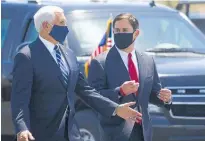  ?? Photo / AP ?? Vice President Mike Pence, left, walks with Arizona Governor Doug Ducey.