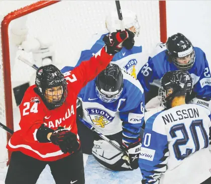  ?? PHOTOS: DEREK LEUNG/GETTY IMAGES ?? Natalie Spooner whoops it up after teammate Jamie Rattray (not pictured) scored to get Canada on the board against Finland in the women's world hockey championsh­ip opener on Friday night in Calgary. Canada rallied from a 2-0 deficit to win 5-3.