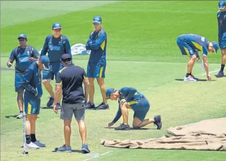  ?? AFP ?? ▪ Australia coach Justin Langer (centre) inspects the Optus Stadium pitch ahead of the second Test against India in Perth on Thursday.