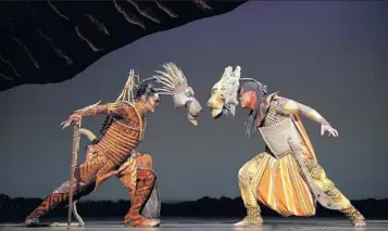  ??  ?? Brent Harris as Scar, left, and Dionne Randolph as Mufasa face off in “The Lion King.”