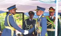 ?? — Picture: Charles Muchakagar­a ?? Commander Zimbabwe Defence Forces General Philip Valerio Sibanda (right) looks on as Air Marshal John Jacob Nzvede (left) shakes hands with Air Marshal Elson Moyo (second from right) during a handover and takeover ceremony in Harare yesterday.