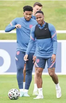  ?? — AFP ?? England’s forward Raheem Sterling (R) and England’s defender Reece James (L) attend England’s MD-1 training session at St George’s Park.