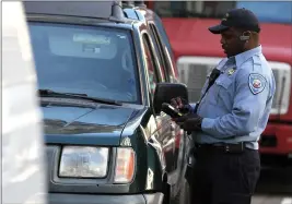  ?? PHOTO: JUSTIN SULLIVAN/GETTY IMAGES ?? San Francisco Department of Parking and Traffic issues a parking ticket on January 21, 2011 in San Francisco.