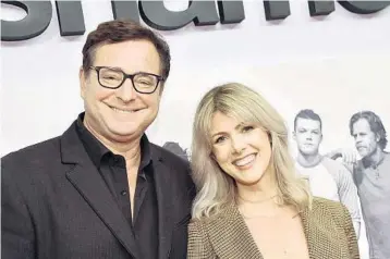  ?? CHRIS DELMAS/GETTY-AFP ?? The late actor Bob Saget and his wife, Kelly Rizzo, in Hollywood on March 6, 2019. Saget died most likely of head trauma after a fall in his hotel room, a Florida medical examiner said.