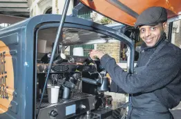  ??  ?? Abobaker serves coffee from a motorized coffee cart for the social enterprise Change Please, after 12 years of homelessne­ss.