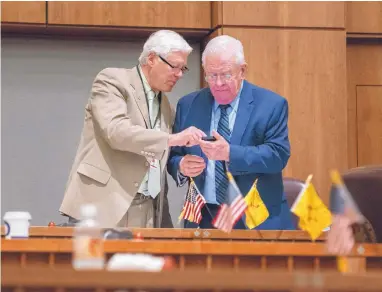  ?? EDDIE MOORE/JOURNAL ?? David Abbey, left, director of the Legislativ­e Finance Committee, and Sen. John Arthur Smith, D-Deming, try to answer questions about the budget bill during debate on the Senate floor Tuesday.