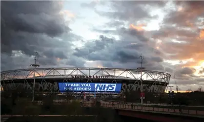  ??  ?? West Ham light up the London Stadium to thank the NHS and other key workers. Photograph: Alex Pantling/Getty Images