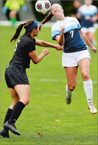  ?? SEAN D. ELLIOT/THE DAY ?? Connecticu­t College’s Mya Johnson heads the ball past Bowdoin’s Sophie Lemmer during Saturday’s NESCAC women’s soccer match at Freeman Field in New London. Johnson, a freshman from Old Lyme, scored the game-winning goal as the Camels beat the Polar Bears 2-1. It was Johnson’s eighth goal of the season and her fifth game-winner this fall.