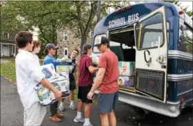  ?? SUBMITTED PHOTO ?? Members of The Hill School’s hockey team load donated supplies into a bus that took them to a container that will be shipped to hurricane victims in Puerto Rico.
