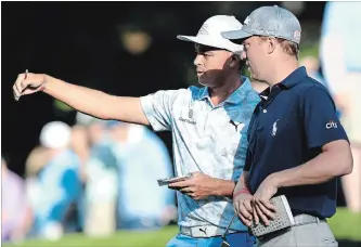  ?? CHARLOTTE OBSERVER FILE PHOTO ?? Rickie Fowler, left, and Justin Thomas discuss the 12th green after putting during the second round of the Wells Fargo Championsh­ip last week.