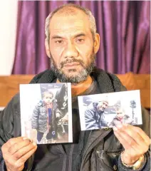  ??  ?? Faouzi Trabelsi shows in Tunis a photo of himself with his grandson, Tamim Jaboudi, who has been trapped in a prison in Libya since his parents, both Tunisians, who left home to join Daesh, died in a US airstrike in February 2016. (AP)