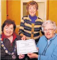  ??  ?? ●●Sybil England received a certificat­e after being a soroptimis­t for 55 years from Ann Welsh and Margaret Brown