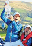  ??  ?? Happy captain: Catriona Matthew is raised high by Suzann Pettersen after Europe’s victory at Gleneagles