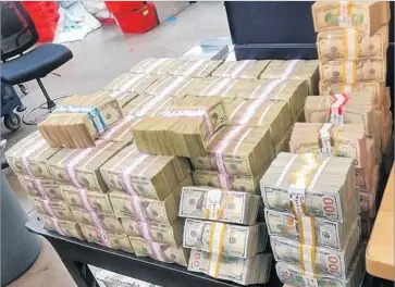  ?? U.S. Border Patrol ?? STACKS OF $100, $20, $10 and $1 bills were confiscate­d from two men — one American and the other Mexican — in the largest cash seizure ever made by U.S. border agents in San Diego County, an official said.