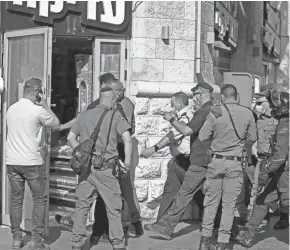  ?? AHMAD GHARABLI/AFP VIA GETTY IMAGES ?? Israeli police arrive at the scene of a stabbing attack in Jerusalem’s central Bus Station on Monday.