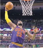  ?? CHARLES KRUPA/ASSOCIATED PRESS ?? Cleveland’s LeBron James soars to the basket for two of his 35 points in Thursday night’s 135-102 win over Boston.