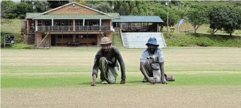  ?? Picture: MARK CARRELS ?? FINAL TOUCHES: Port Alfred Country Club Ground staff Solomon Lepile, left, and Joe Gova make sure the pitch is in tip-top shape for the 120th edition of the Pineapple Cricket Tournament that hits off from March 2 to March 9.