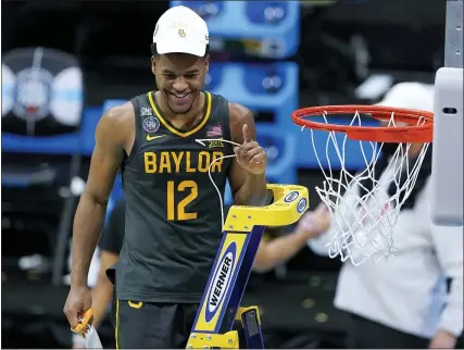  ?? PHOTOS BY DARRON CUMMINGS — THE ASSOCIATED PRESS ?? Baylor guard Jared Butler cuts down the net after the championsh­ip game against Gonzaga in the men’s Final Four NCAA tournament on Monday at Lucas Oil Stadium in Indianapol­is. Baylor won 86-70.