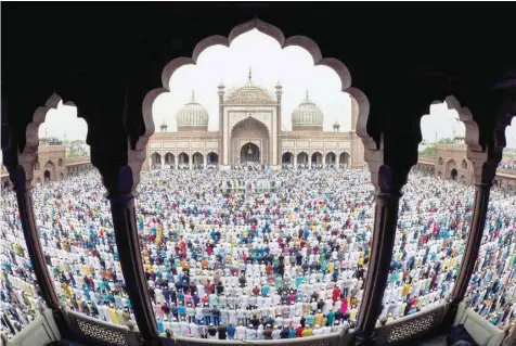  ?? — AFP ?? Muslims offer Eid al Fitr prayers at the Jama Masjid Mosque in New Delhi on Saturday.