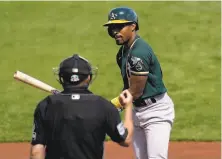  ?? Ross D. Franklin / Associated Press ?? A’s utility man Tony Kemp talks with umpire Jansen Visconti after striking out swinging in the second inning Monday.