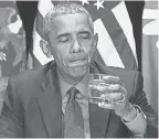  ?? JIM WATSON/AFP/GETTY IMAGES ?? Barack Obama takes a drink in Flint in May 2016.