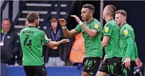  ?? ?? KET STRIKE: Jacob Brown scores Stoke’s winner at Luton, main, and, right, celebrates his goal with team-mates.