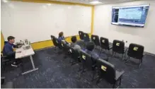  ?? STAFF PHOTOS BY MATT HAMILTON ?? UTC receivers watch footage from football practice in a video room at the Wolford Family Athletics Complex on Friday.