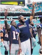  ?? BRYNN ANDERSON/ASSOCIATED PRESS ?? New England Patriots receiver Antonio Brown, left, celebrates with teammate Deatrich Wise during Sunday’s victory over Miami. Brown had a touchdown in the win.