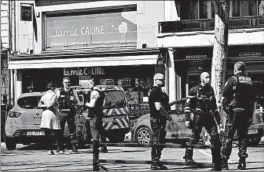  ?? JEFF PACHOUD/GETTY-AFP ?? Police stand in a street Saturday in Romans-sur-Isere, France, after a man attacked several people with a knife. Two people were killed and five others were injured.