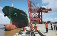  ?? YAO FENG / FOR CHINA DAILY ?? A COSCO ship docks at Zhoushan, Zhejiang province.