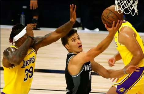  ?? Kevin C. Cox/Pool Photo via AP ?? Sacramento Kings’ Bogdan Bogdanovic (8) goes up for a shot against Los Angeles Lakers’ Dwight Howard (39) during the second quarter of an NBA basketball game on Aug. 13 in Lake Buena Vista, Fla.