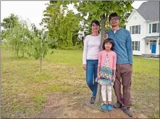  ?? SEAN D. ELLIOT/THE DAY ?? Purba Mukerji, left, Ali Rangwala, and their daughter, Meera, 8, stand by the row of trees in front of their East Lyme home.