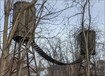  ?? PHOTO BY CHRISTOPHE­R NILAN ?? The two towers that make up the structure are connected by a wooden bridge.