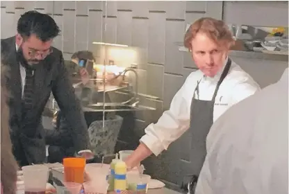  ?? NEIL STEINBERG/ SUN- TIMES ?? Chef Grant Achatz ( right) in the kitchen of Alinea, his world- renowned Lincoln Park restaurant, last Sunday night. A dinner there can cost $ 420. Without wine.