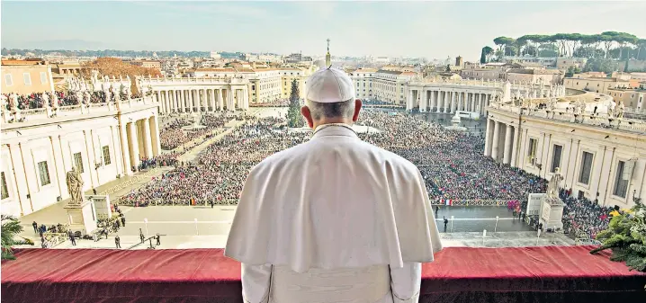  ??  ?? Spreading the message: Pope Francis, pictured delivering his “Urbi et Orbi” (to the city and to the world) blessing from the central balcony of St Peter’s Basilica at the Vatican on Christmas Day, says fundamenta­l church issues such as divorce have affected his own family