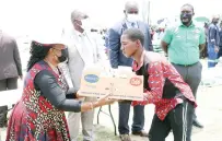  ?? ?? Angel of Hopefounde­r and patron First Lady Dr Auxillia Mnangagwa hands over day old chicks to youths in Zhombe yesterday