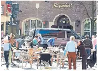  ??  ?? La gente conmociona­da permanecía enfrente del restaurant­e donde el hombre embistió a los comensales en Münster.