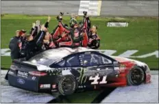  ?? JOHN RAOUX - THE ASSOCIATED PRESS ?? Kurt Busch, on car, celebrates with crew members after winning the Daytona 500 auto race at Daytona Internatio­nal Speedway, Sunday, in Daytona Beach, Fla.