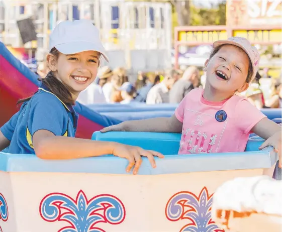  ?? Picture: JERAD WILLIAMS ?? Maddison Vecanski, 9, and Ruby Home, 7, enjoy one of the rides at the hugely successful Mudgeeraba Show yesterday.