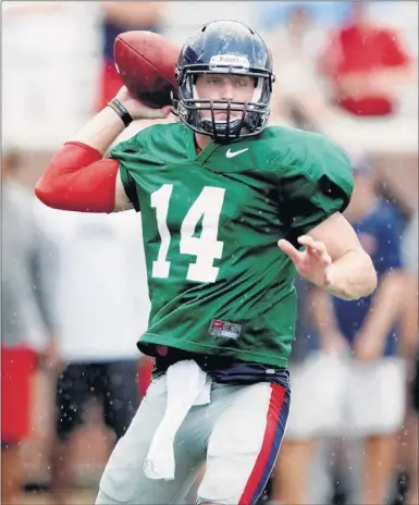  ?? BRUCE NEWMAN/ASSOCIATED PRESS ?? Bo Wallace looks to pass during a scrimmage earlier this month at Vaught-Hemingway Stadium. Wallace underwent surgery on his throwing shoulder in January, but has been practicing at full speed recently as the Rebels prepare for Thursday’s season opener...