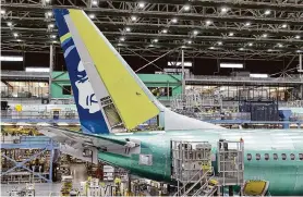  ?? Ellen M. Banner/Tribune News Service ?? Boeing employees work on the 737 Max in June at Boeing’s plant in Renton, Wash. FAA has placed “about two dozen” inspectors at the plant.