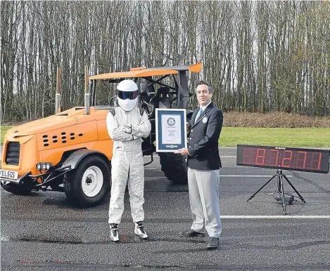  ??  ?? TOP Gear’s mysterious high-speed racer The Stig has set a new world record in a modified tractor.
The driver took the Guinness World Record for fastest tractor with a speed of 87.2mph after presenter Matt LeBlanc tried to revolution­ise British...