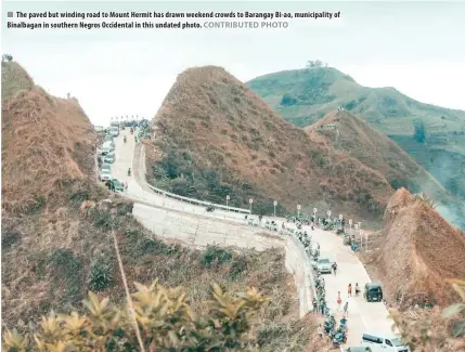  ?? CONTRIBUTE­D PHOTO ?? The paved but winding road to Mount Hermit has drawn weekend crowds to Barangay Bi-ao, municipali­ty of Binalbagan in southern Negros Occidental in this undated photo.