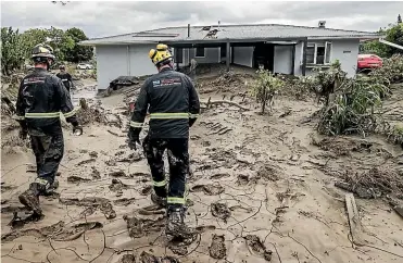  ?? CHRIS SKELTON/ STUFF ?? Rescue teams search a property in Esk Valley after Cyclone Gabrielle.