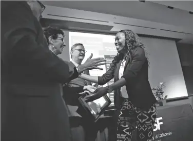  ?? Photos by Scott Strazzante / The Chronicle ?? Graduate Tanika Page hugs Abby Snay of Jewish Vocational Services during the ceremony at UCSF.