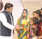  ?? — PTI ?? UP CM Akhilesh Yadav hands over 20 lakh cheques to the families of Army and police personnel in Lucknow on Tuesday.