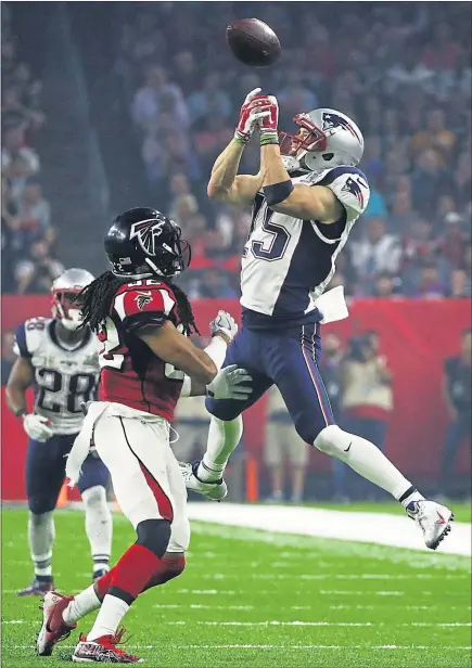 ??  ?? FALLING PREY: Atlanta Falcons intercept a pass but New England Patriots clawed their way back to let quarterbac­k Tom Brady lift Lombardi Trophy for the fifth time.