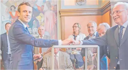  ??  ?? President Emmanuel Macron (left) casts his ballot in Le Touquet, northern France.